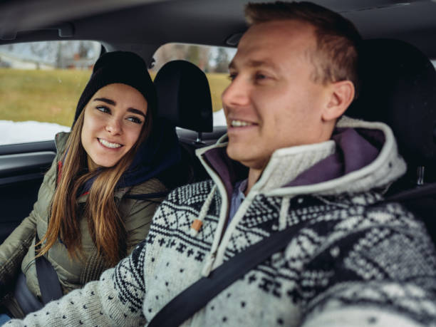 istock Millennial couple driving in a car in winter 1087085896