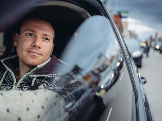 istock Millennial man driving in a car in winter 1087086424