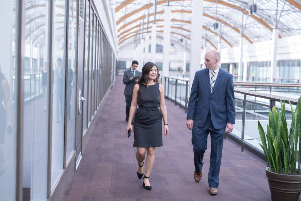 istock Two colleagues talking on their way to a meeting 1087089394