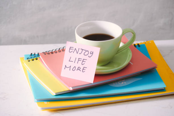 istock Green cup with sticker and notebooks on tabletop. 1087089508