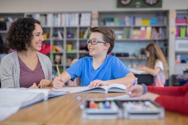 istock Teacher helping 4th graders in her classroom 1087097762