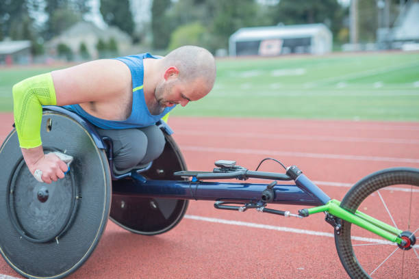 istock Adaptive athlete training on his racing wheelchair on a stadium track 1087102080