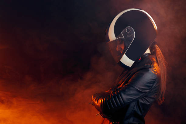 Biker Woman with Helmet and Leather Outfit Portrait Cool competitive female motorcyclist wearing protective gear biker stock pictures, royalty-free photos & images