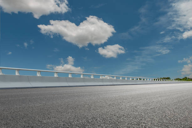 istock Overpass, asphalt pavement and modern architecture    Urban road surface background 1087107474