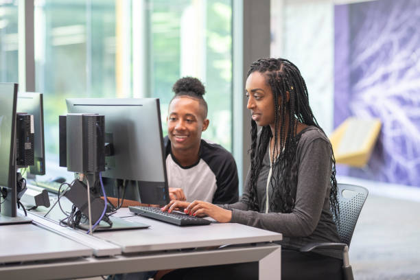 istock College students working at a computer station in the library 1087109186