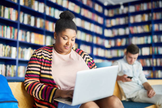 istock Portly African student girl using laptop 1087111720