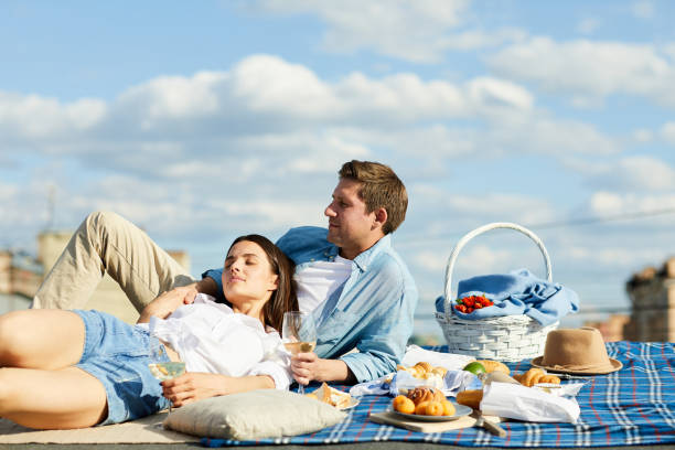 istock Relaxed couple at roof picnic 1087113396