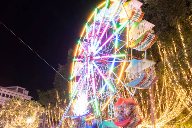 Defocused ferris wheel with colorful lights, Blur abstract background ready for your design
