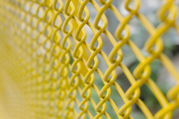 istock yellow wire fence close up 1087117928