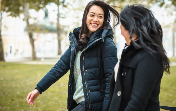 istock Two women walking in the park and talking 1087119758