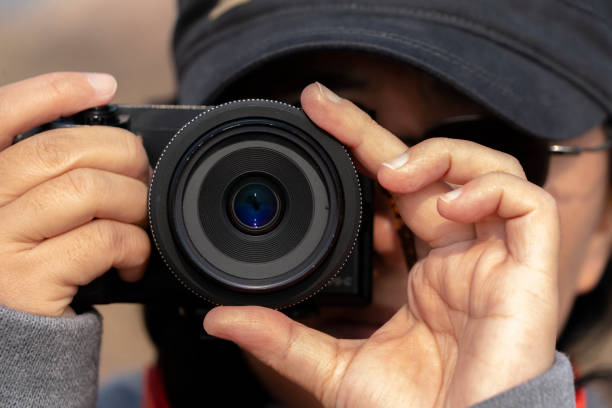 istock young female photographer holding camera 1087119984