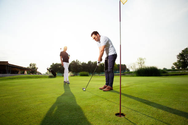 istock Young couple at golf court 1087149156