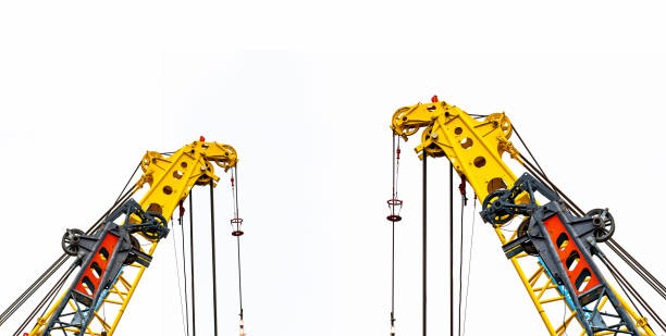 istock Big yellow construction crane for heavy lifting isolated on white background. Construction industry. crane for container lift or at construction site. Crane rental business concept. Crane dealership. 1087149980