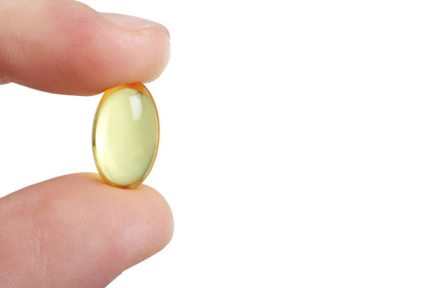 istock Fish oil pills lie in hand 1087153688