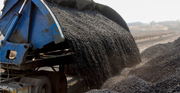 istock Truck tipping a load of processed coal beside a railway siding 1087153912