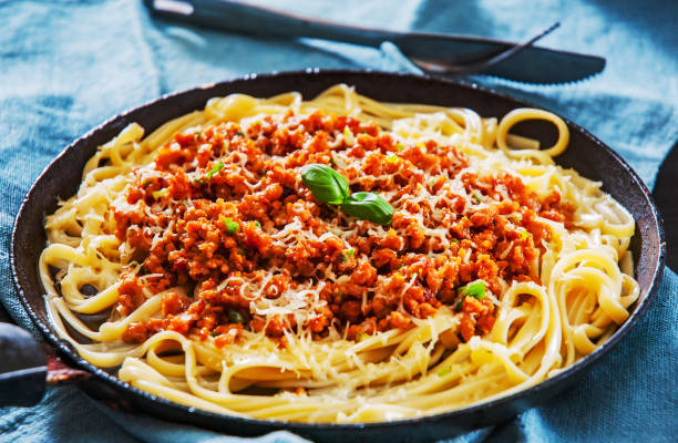 istock Traditional pasta spaghetti bolognese in a frying pan 1087154590