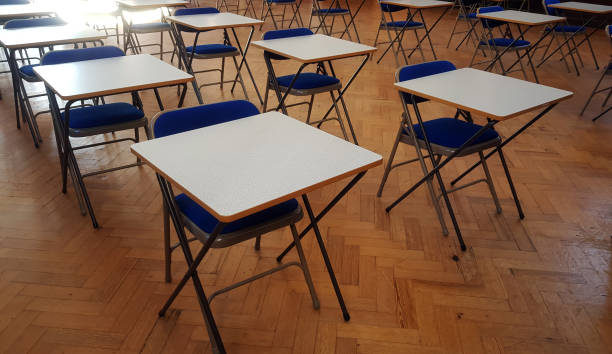 istock Exam desk in a hall 1087160090