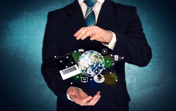 istock Business person holding laptop and globe 1087161440