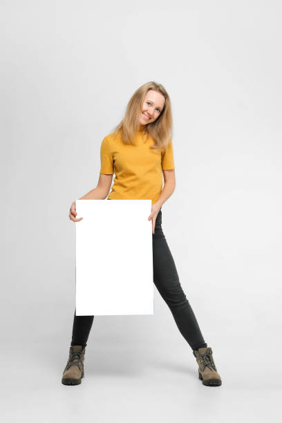 istock Smiling young woman with poster 1087163416