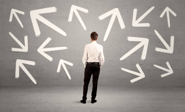 istock Confused salesman with arrows on wall 1087164902