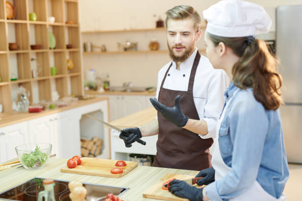 istock Two Professional Chefs Cooking in Cafe 1087167662