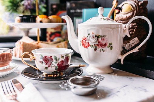 English Vintage Porcelain Roses Tea Sets including teapot, tea cup, plate, spoon and tea filter.