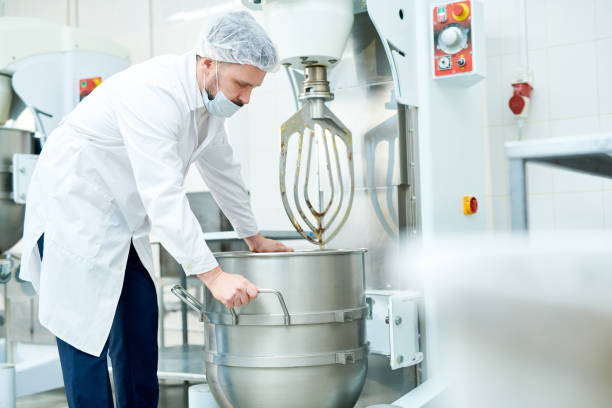 istock Confectionery factory employee working with machinery 1087171476