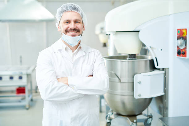 istock Confectionery factory worker standing and smiling 1087171478
