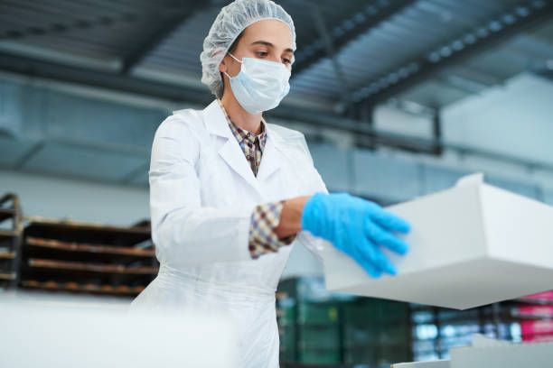 istock Confectionery factory worker holding paper box 1087171570