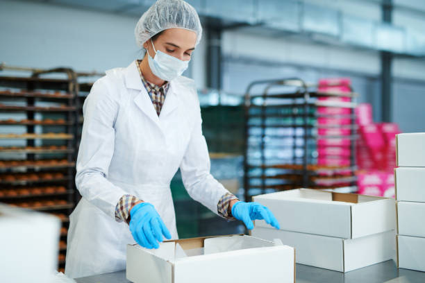istock Confectionery factory worker preparing package 1087171578