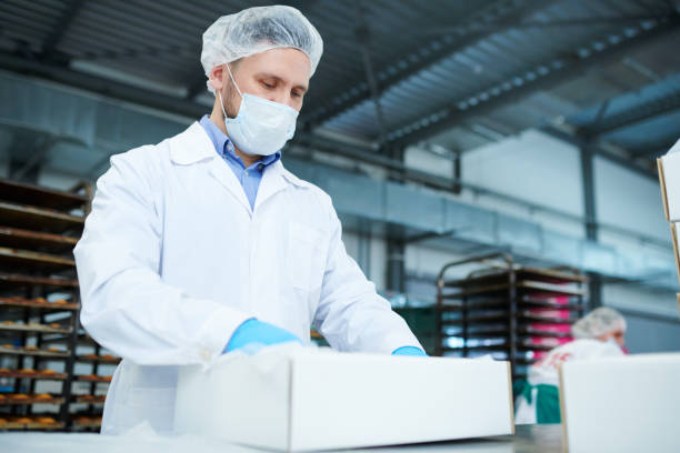 istock Confectionery factory employee preparing package 1087171582
