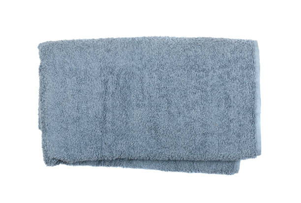 istock Gray rolled or folded hotel towel isolated on white close up 1087174494