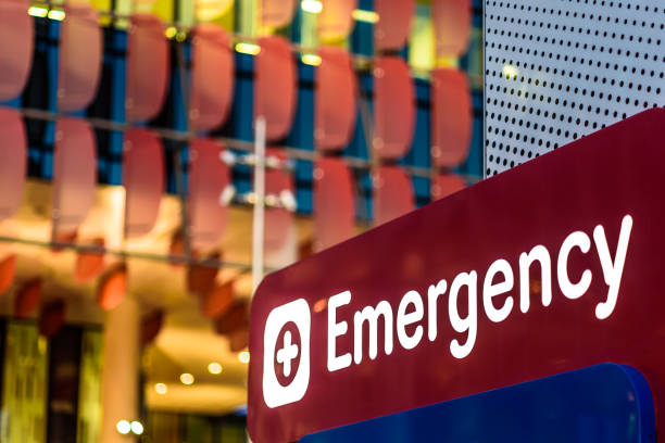 Emergency Sign An "Emergency" Sign in front of a hospital in the early evening emergency room photos stock pictures, royalty-free photos & images
