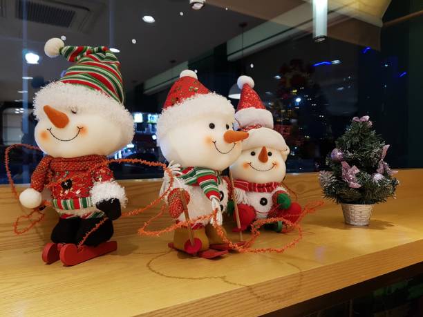 istock cute snowman dolls with red hat for winter interior 1087176586