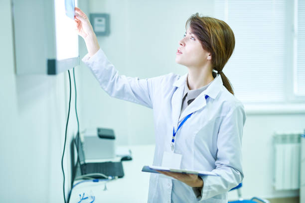istock Doctor standing and looking at X-ray 1087181322