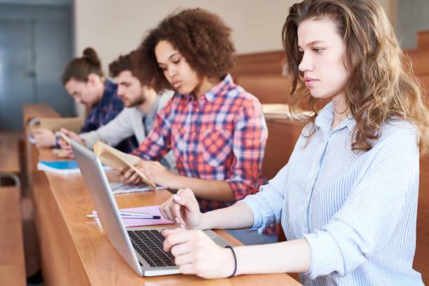 istock Concentrated university student preparing for test with laptop 1087181622