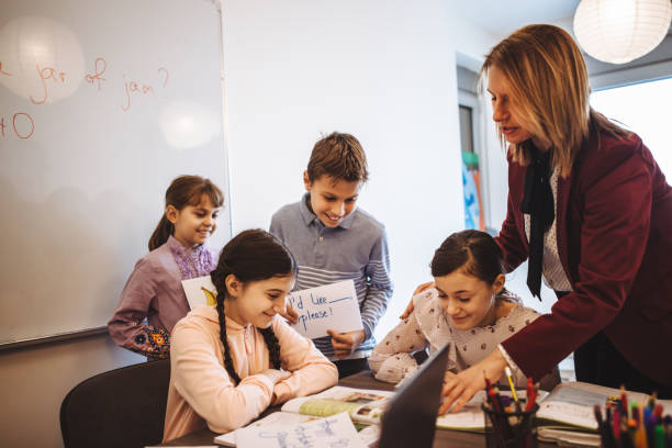 istock female teacher teaching  kids in classroom 1087182938