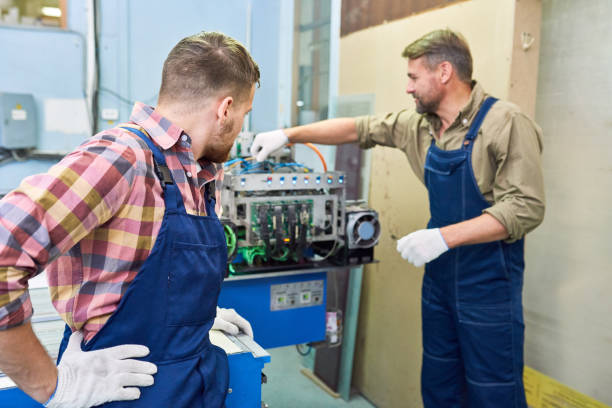 istock Two Mechanics Fixing Machine at Factory 1087183072