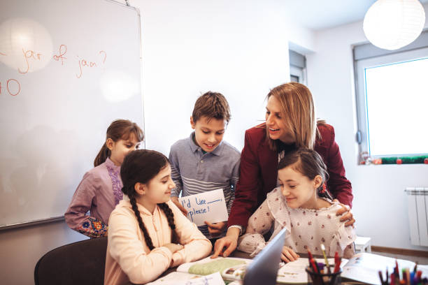 istock female teacher teaching  kids in classroom 1087183146