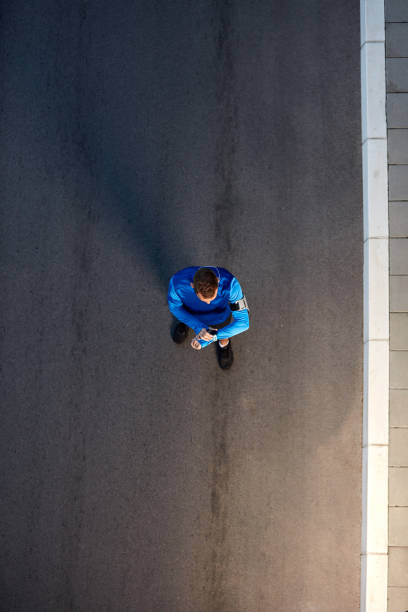 istock Top view of runner standing and watching at wristwatch. 1087184054