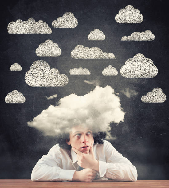 istock Thoughtful man with an cloud on his head against a blackboard drawn with clouds. 1087185944
