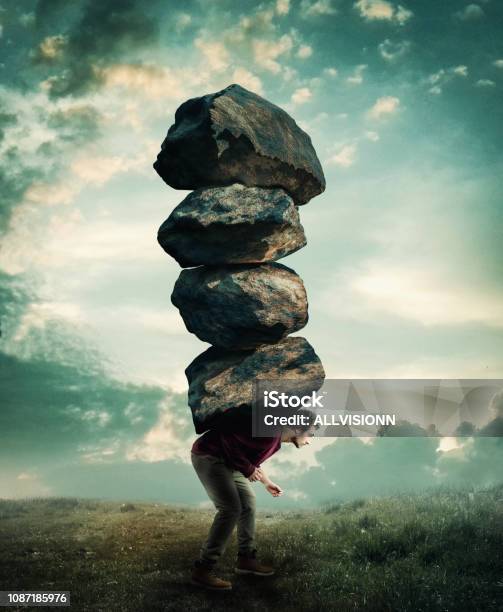 Man Carries A Stack Of Heavy Rocks Stock Photo - Download Image Now - Over-Burdened, Emotional Stress, Struggle