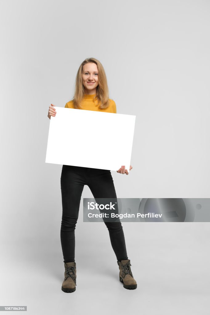 Mulher jovem sorridente com poster - Foto de stock de Segurar royalty-free