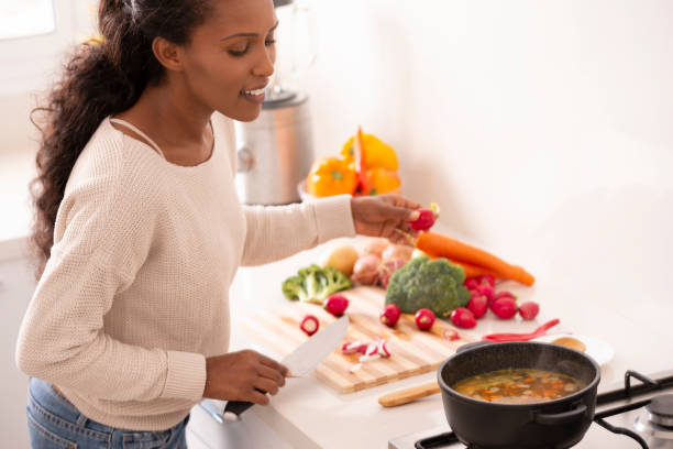 istock Female cook watching a pot boil. 1087188236