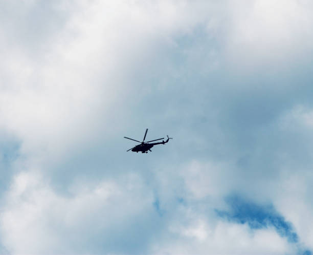 istock Helicopter flightning in blue sky with clouds 1087193006