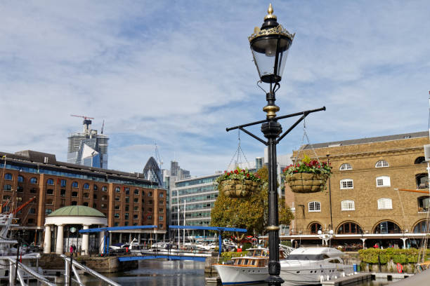 St Katherine's Dock, London, United Kingdom, January 25, 2025. West Dock, luxury marina development. Retail units, superyachts and motor boat cruisers. Sunny winter day outdoors.