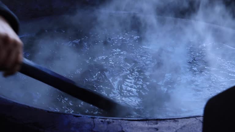 Boiling fabric in the pot to natural tie and dye a procedure to weaving in Thailand
