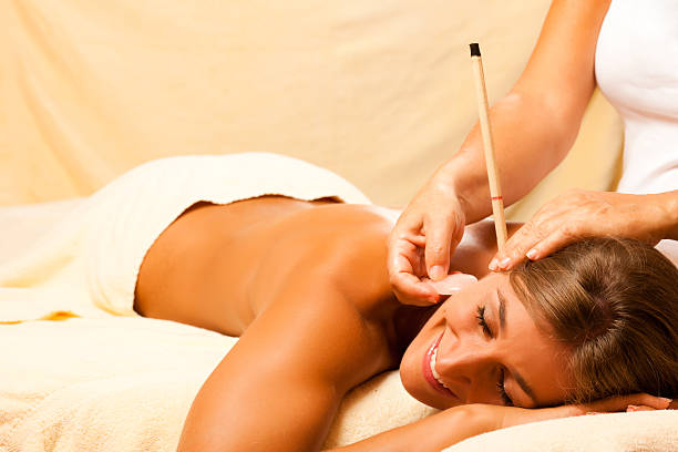 istock Woman with ear candles and gem massage 108719959