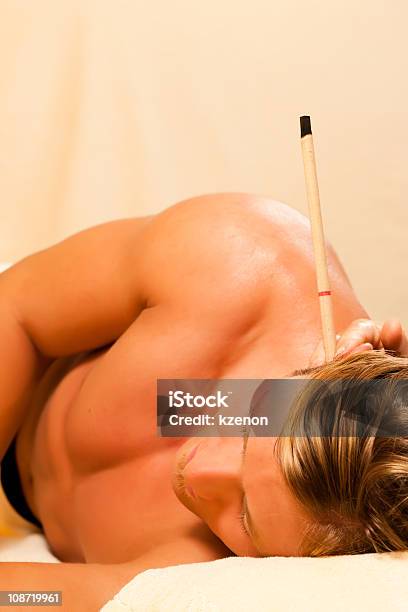 Man In Therapy With Ear Candles Stock Photo - Download Image Now - Ear Candling, Adult, Alternative Medicine