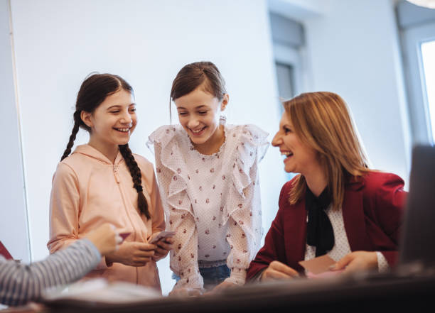 istock female teacher teaching  kids in classroom 1087204636